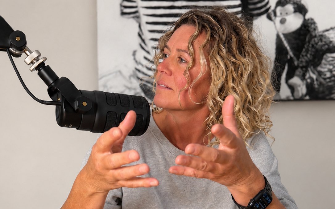 Krissie Steen talking at a podcast microphone